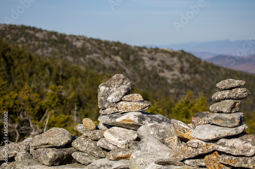 Cairns on a small stone wall guide hikers on their way to the rocky summit of Cardigan Mountain © Joshua Conover
