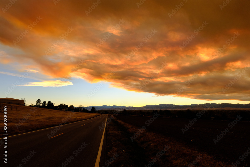 Smoke from the nearby Cameron Peak forest fire obscures a beautiful sunset in Westminster Colorado