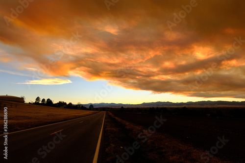 Smoke from the nearby Cameron Peak forest fire obscures a beautiful sunset in Westminster Colorado