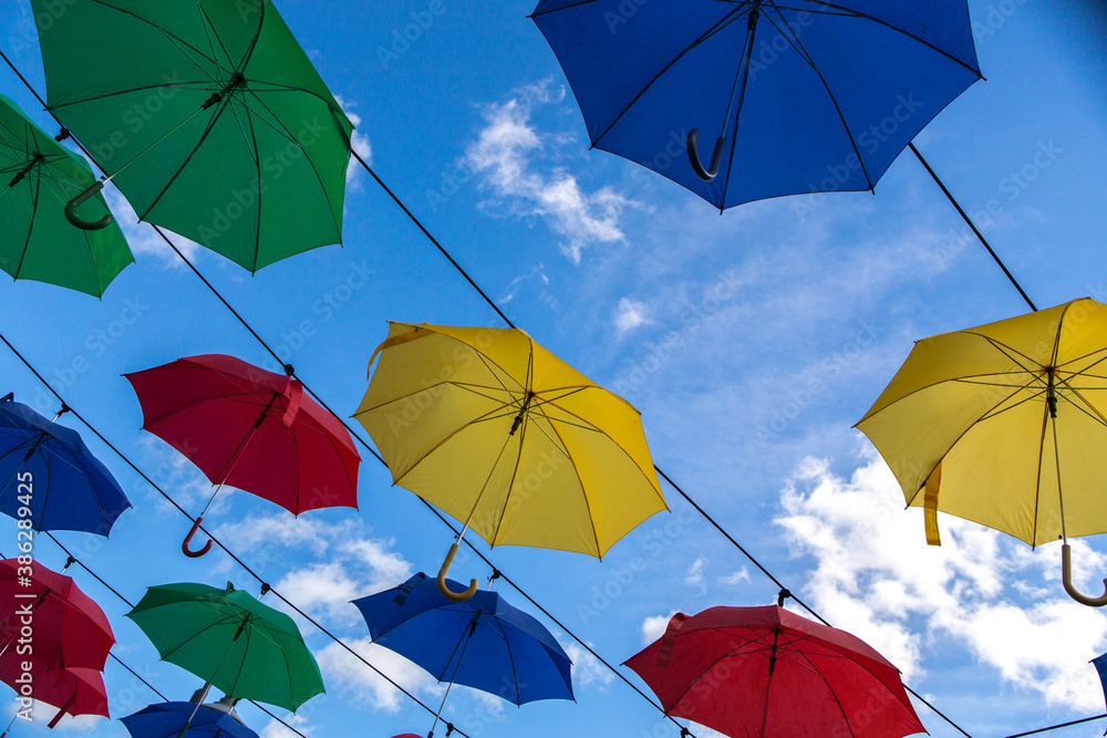 Umbrella street decoration. The blue sky of colorful umbrellas in the city. Umbrella Sky Project.