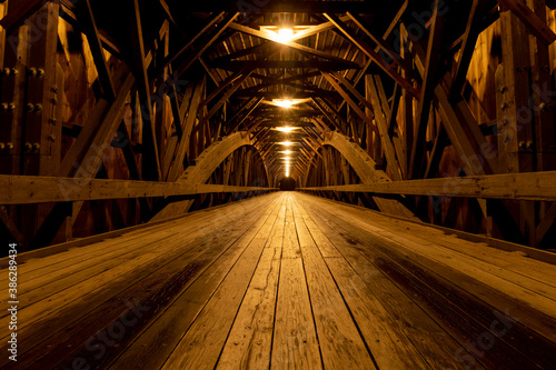Modern lights brighten the wooden structure of the Blair Covered Bridge in Campton, New Hampshire