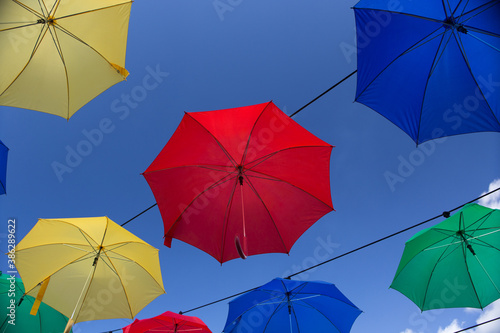 Umbrella street decoration. The blue sky of colorful umbrellas in the city. Umbrella Sky Project.