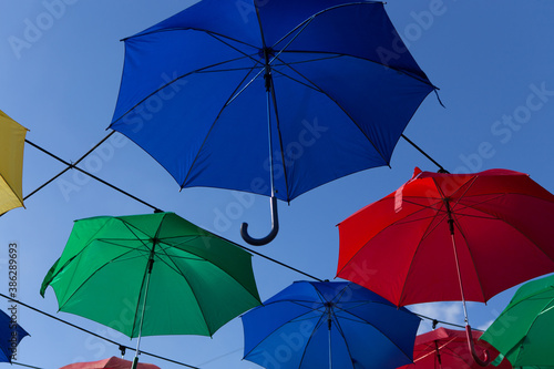 Umbrella street decoration. The blue sky of colorful umbrellas in the city. Umbrella Sky Project.