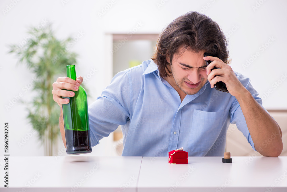 Young male alcoholic in unrequited love concept