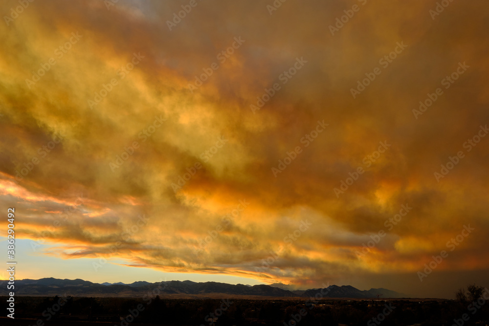 Smoke from the nearby Cameron Peak forest fire mixes with the clouds during sunset creating unique colors in Westminster, Colorado, 2020 Smoke from the nearby Cameron Peak forest fire mixes with the clouds during sunset creating unique colors in Westminster, Colorado, 2020