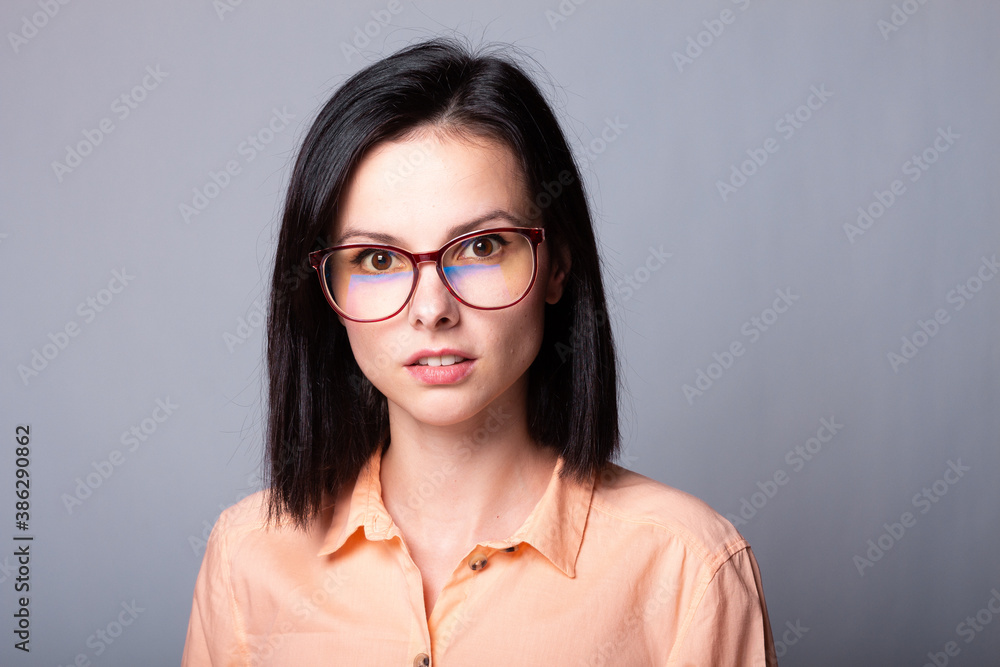 cute woman in glasses, gray background cute woman in glasses, gray background