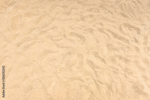 background and texture of yellow sand pattern on a beach in summer