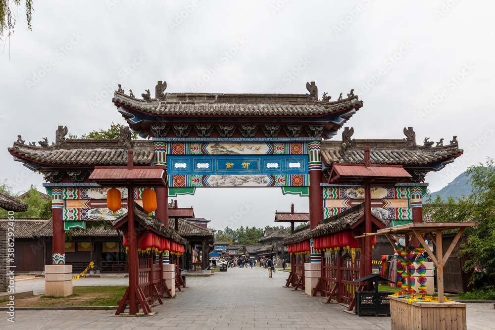 Naklejka premium Gateway at Riverside Scene at the Pure Moon Festival, one of Hengdian World Studios in Dongyang, Jinhua, Zhejiang, China. Recreation of famous Song dynasty painting.
