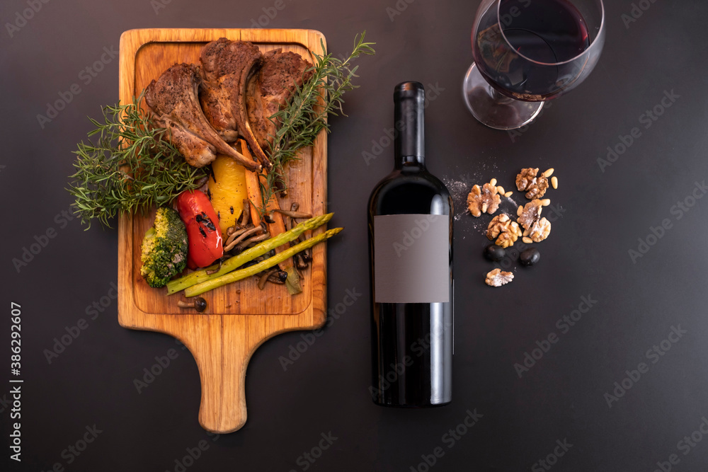 Bottle of wine lying down in black background with some food as
