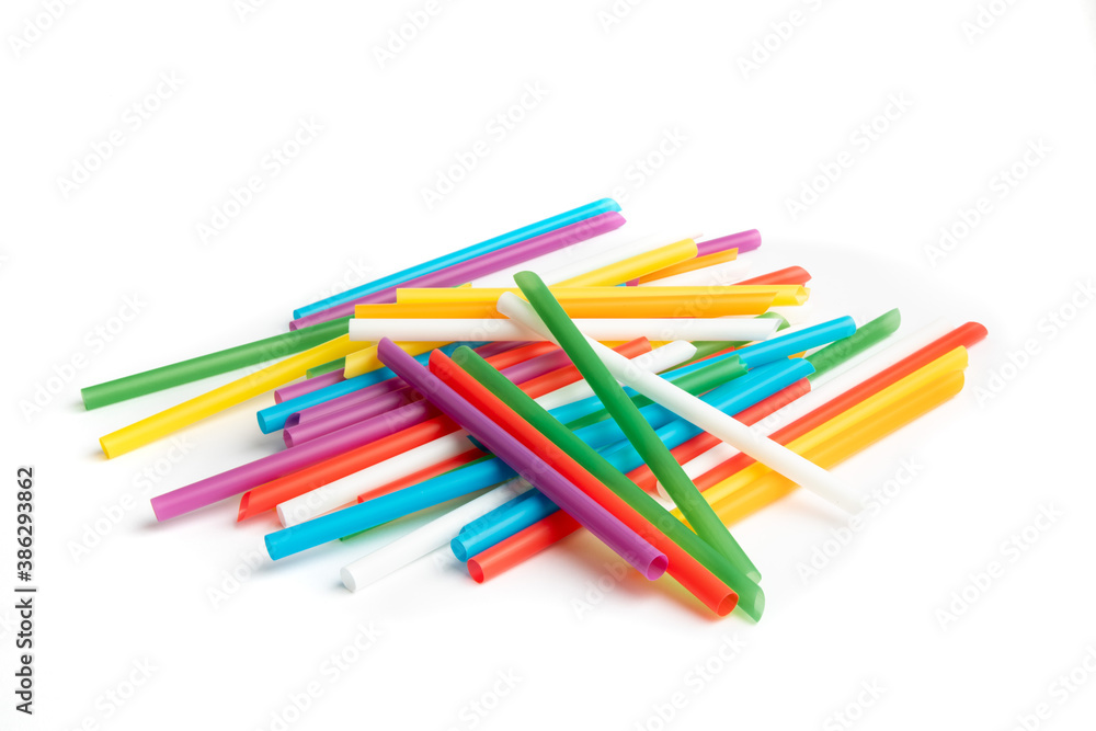A pile of colorful single use plastic straws isolated on white A pile of colorful single use plastic straws isolated on white