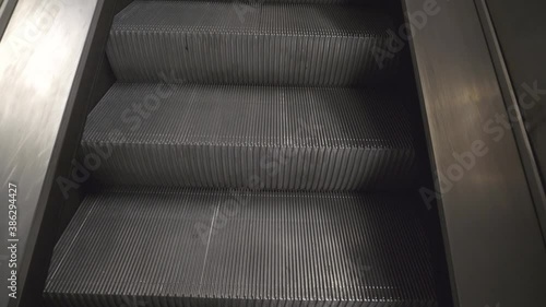 A view of escalator steps ascending in an underground.
