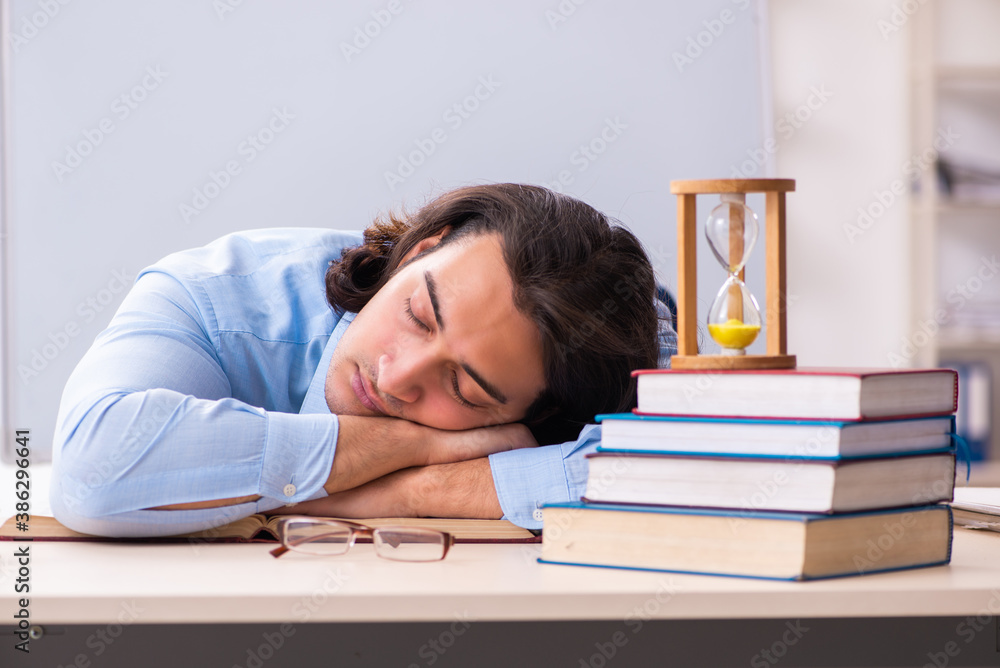 Young businessman student in time management concept Young businessman student in time management concept