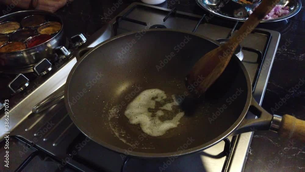 Close Up of Ghee Melting in Hot Pan During Cooking Class in Munnar, Kerala, India. Close Up of Ghee Melting in Hot Pan During Cooking Class in Munnar, Kerala, India.