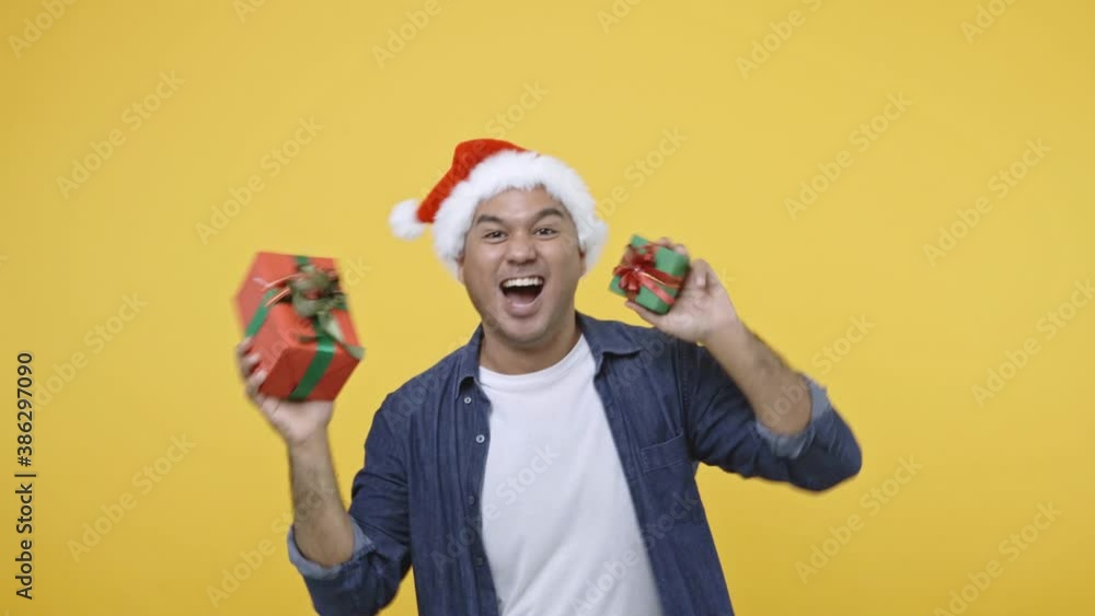 A man was celebrating Christmas and New Year's Day, getting into a gift box, he was delighted and jumping around. 4K Resolution. A man was celebrating Christmas and New Year's Day, getting into a gift box, he was delighted and jumping around. 4K Resolution.