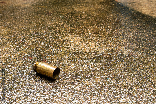 Empty bullet shells Is on the wet pavement background