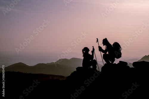 Couple on the Top of Mountain at Sunset