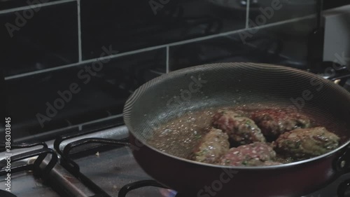 Woman cooking Kofta in a fried pan photo