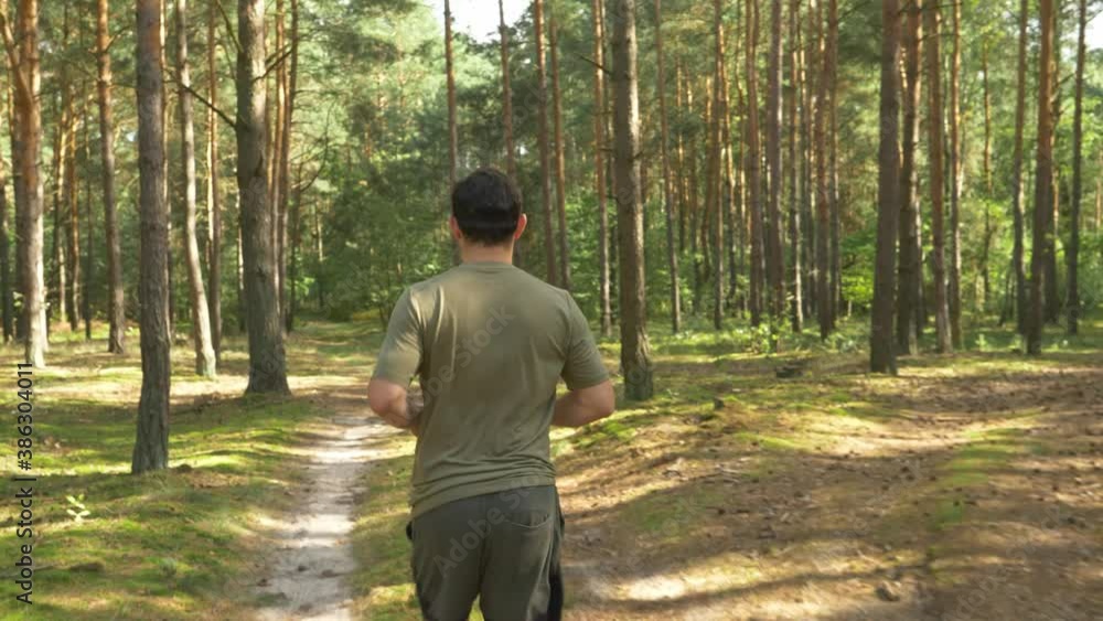 Man Running In The Forest At Early Morning Near The Arendel Village In Zagorow, Poland. - tracking shot
