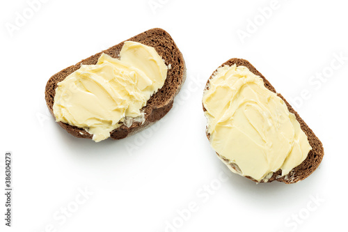 two pieces of bread with butter isolated white background