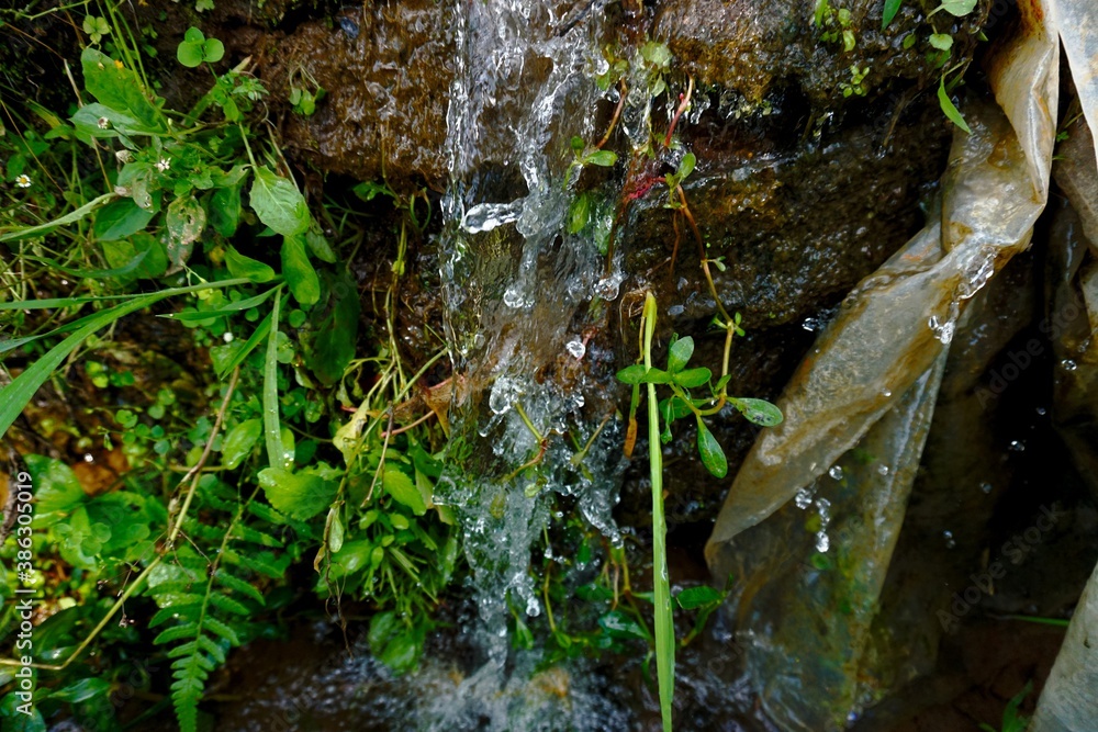 Natural water source in the mountains, The water falls from the rocks. Natural water source in the mountains, The water falls from the rocks.