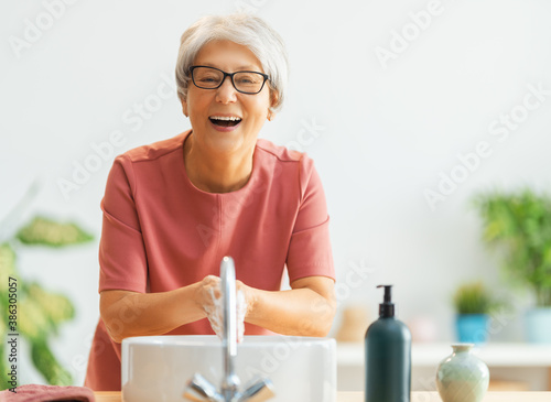 Person is washing hands with soap. photo