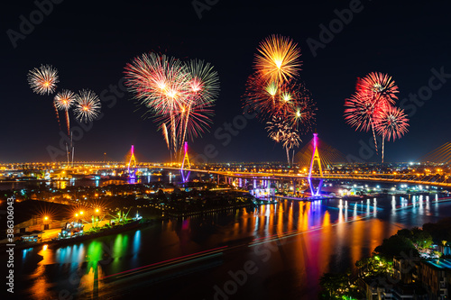 Photography fireworks over Bhumibol suspension bridge at night in Bangkok city, Thailand