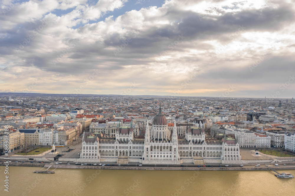Aerial drone shot of Hungarian Parliament with overcast clouds in Budapest Winter morning