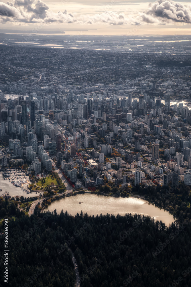 Obraz premium Downtown Vancouver, British Columbia, Canada. Aerial View of the Modern Urban City, Stanley Park, Harbour and Port. Viewed from Airplane Above during a sunny morning. Artistic Render