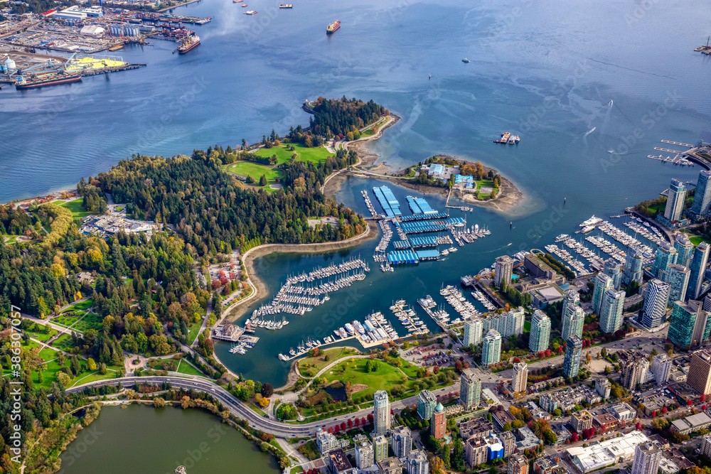 Aerial view of Coal Harbour and a modern Downtown City during a vibrant sunny morning. Taken in Vancouver, British Columbia, Canada.