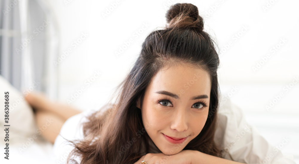Smiling of cheerful beautiful pretty asian woman clean fresh healthy white skin posing in white clothes.Girl felling relaxing and enjoy time on the bed at home.asia beauty Smiling of cheerful beautiful pretty asian woman clean fresh healthy white skin posing in white clothes.Girl felling relaxing and enjoy time on the bed at home.asia beauty