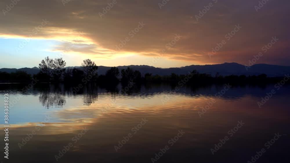 Reflection of colorful clouds over lake surface Reflection of colorful clouds over lake surface