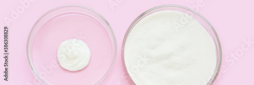 Collagen white powder. Pastel color background. Health product. Woman cosmetics concept. Sport supplement. Skincare cosmetics. Horizontal banner. Pink monochrome. Cream smear