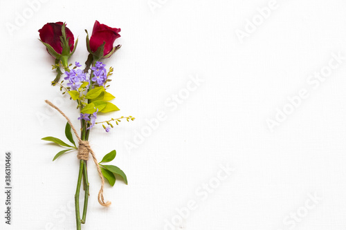 background nature texture red rose and purple flowers arrangement flat lay postcard style on white wooden