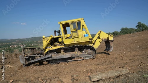 Earthworks Dozer (Bulldozer) Excavator in mountainous terrain, land correction and field clearing