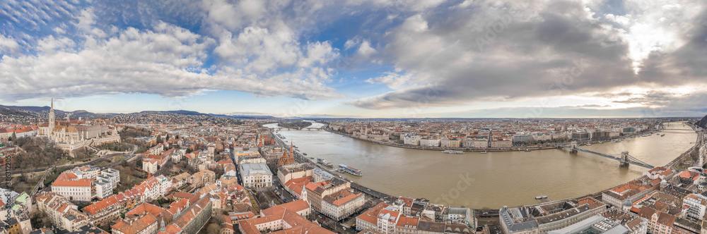 Aerial panoramic drone shot of Hungarian Parliament by Danube in Budapest winter morning