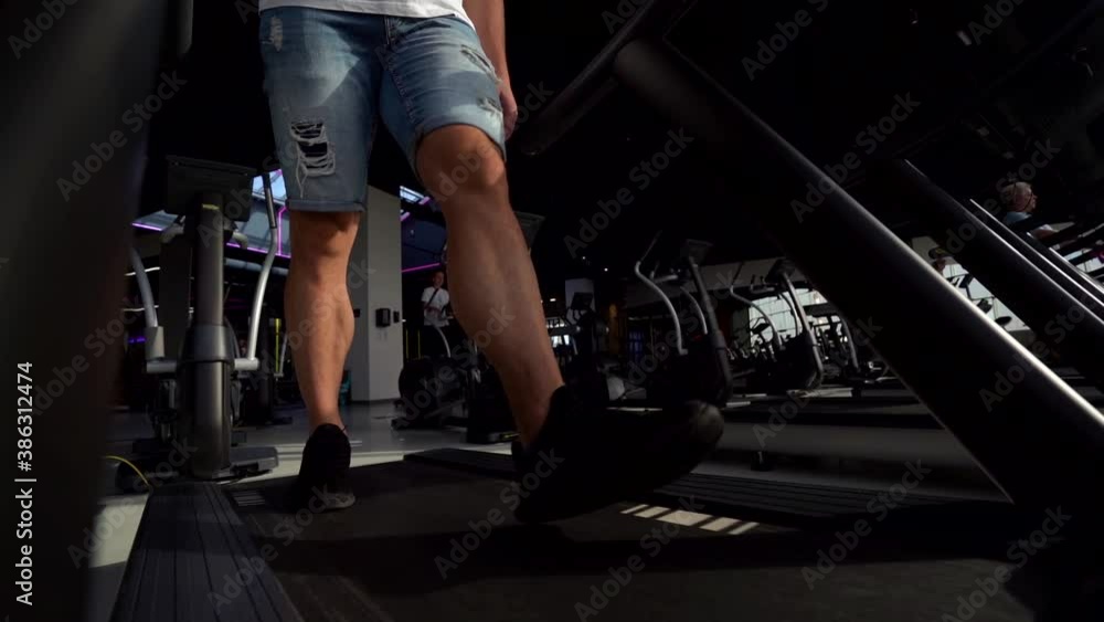 treadmill training in gym, detail view on male legs, sportsman is walking, sport activity and health style treadmill training in gym, detail view on male legs, sportsman is walking, sport activity and health style