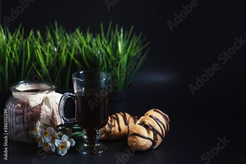 French breakfast on the table. Coffee croissant with chocolate and a decanter with cream. Fresh pastries and decaffeinated coffee.