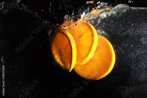 Water drops on ripe sweet orange. Fresh mandarin background with copy space for your text. Vegetarian concept. photo