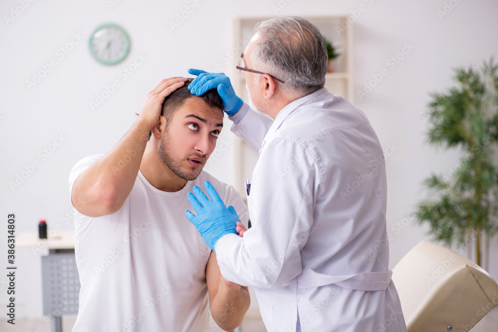 Fototapeta premium Young man visiting experienced doctor dermatologist