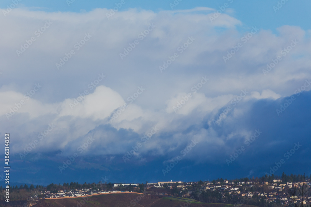 Rain Clouds Rolling Over Hills Near Town