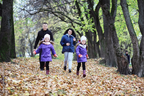 Leaf fall in the park. Children for a walk in the autumn park. Family. Fall. Happiness.
