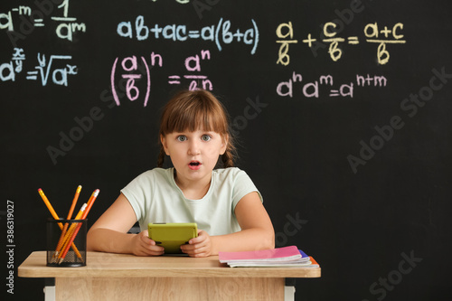 Cute pupil with calculator ...