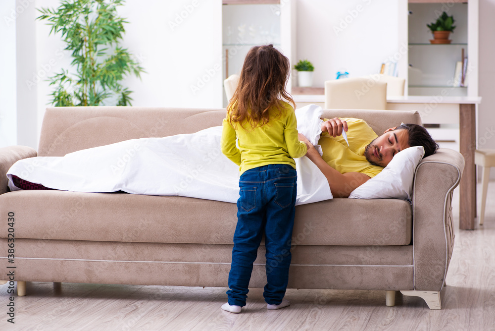 Fototapeta premium Small girl looking after her sick father