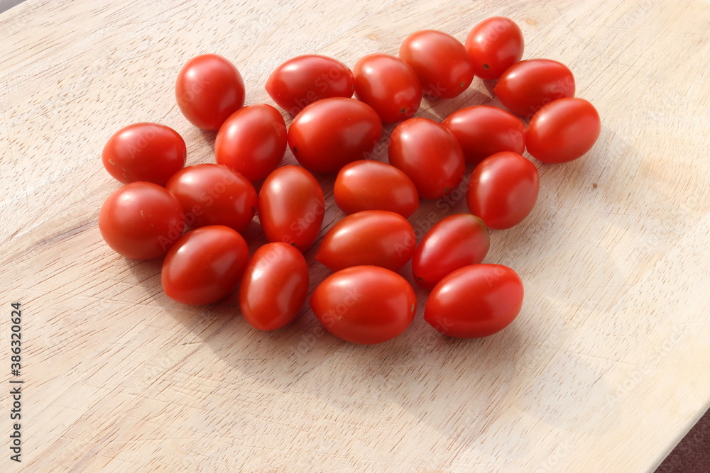 Cherry Tomatoes on a wooden chopping board Cherry Tomatoes on a wooden chopping board
