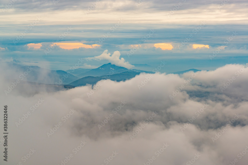 Mountain peaks and low clouds.