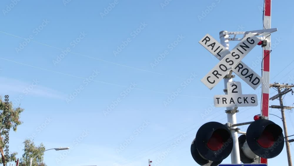 Level crossing warning signal in USA. Crossbuck notice and red traffic