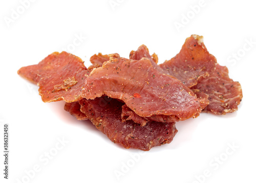 Spicy dry-cured meat isolated on a white background.