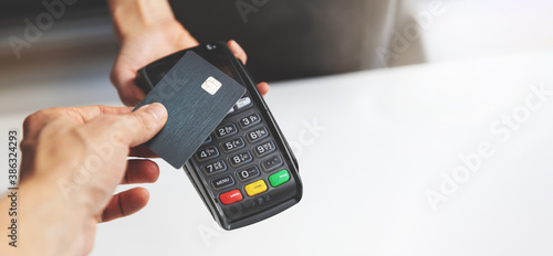 nfc contactless payment by credit card and pos terminal. copy space photo