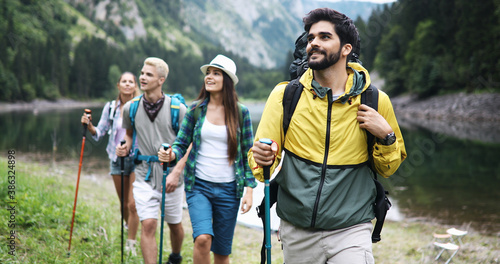 Group of fit healthy friends trekking in the mountains photo