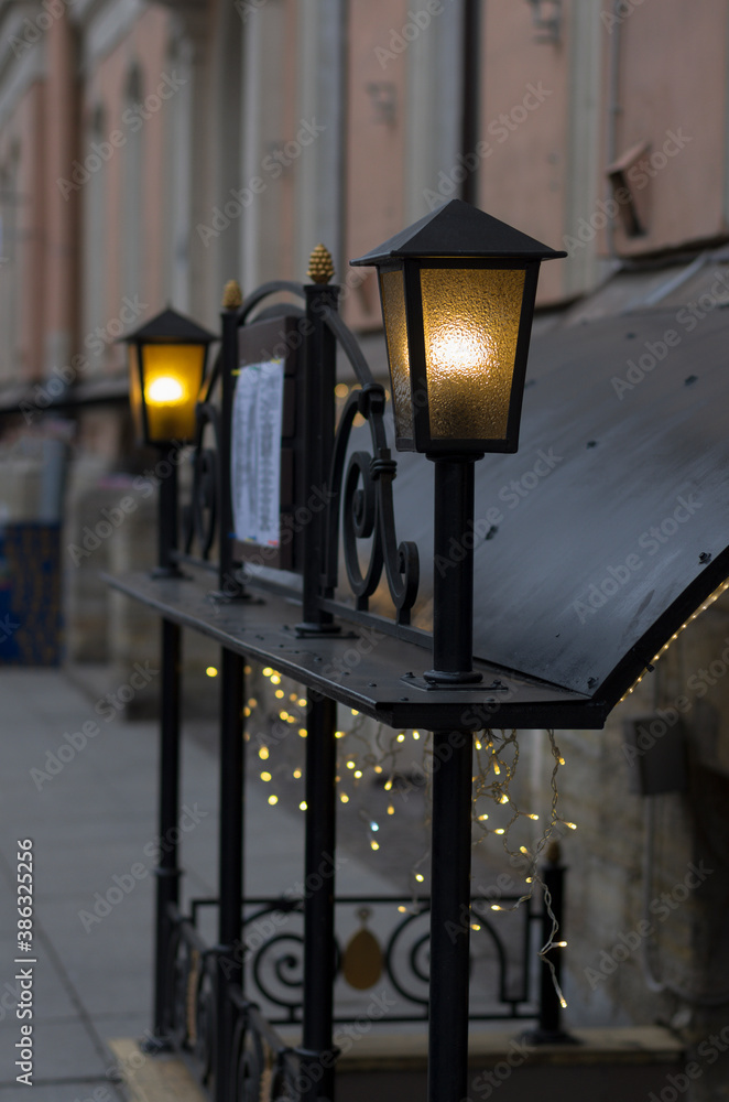 Two glowing street lamps near the cafe stylized as old gas lamps Two glowing street lamps near the cafe stylized as old gas lamps
